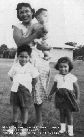 Mary Resendez holds her youngest child, Gerardo, in 1953 while her two other children, Rudolpho and Mary Frances, stand by.