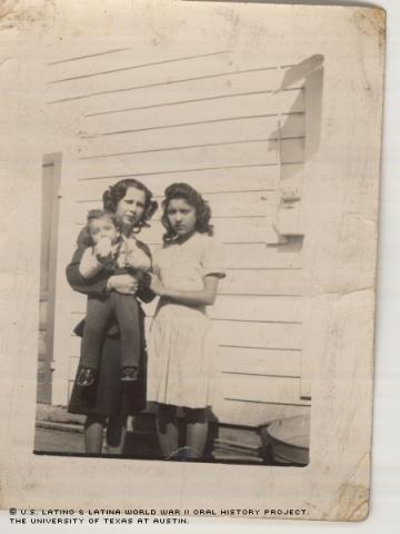Henrietta Rivas holds her son Robert and poses with Nikie Garcia in 1947 in Charlotte, Texas. This photograph is part of the personal collection of Henrietta Rivas, one of many Latina participants serving the United States during WWII.