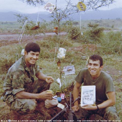 Manuel Lugo, right, and a friend, photographed in 1969 at Hill 33 on Christmas day with an improvised Christmas tree.